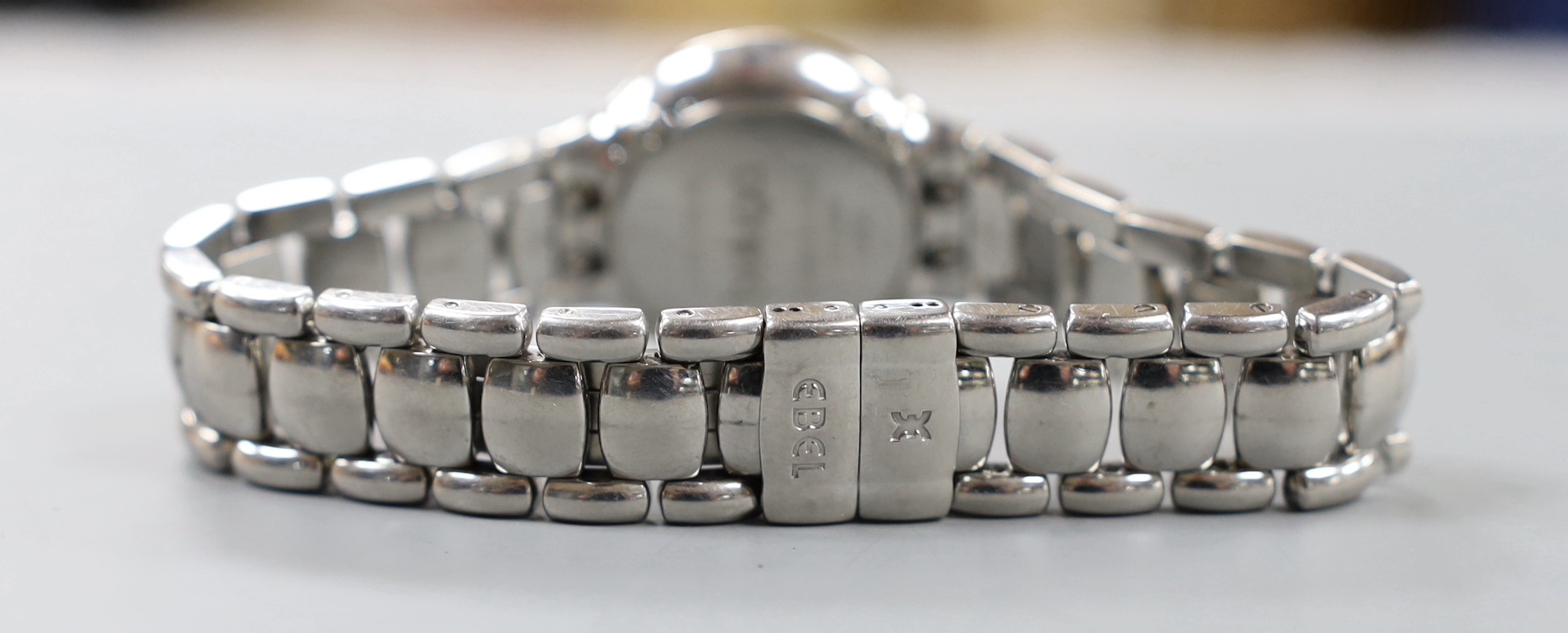 A lady's modern stainless steel Ebel quartz wrist watch and bracelet with diamond set dial and bezel, with box and papers.